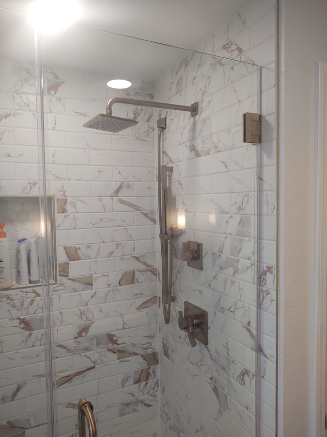 Tile shower with stainless fixtures and rain shower head
